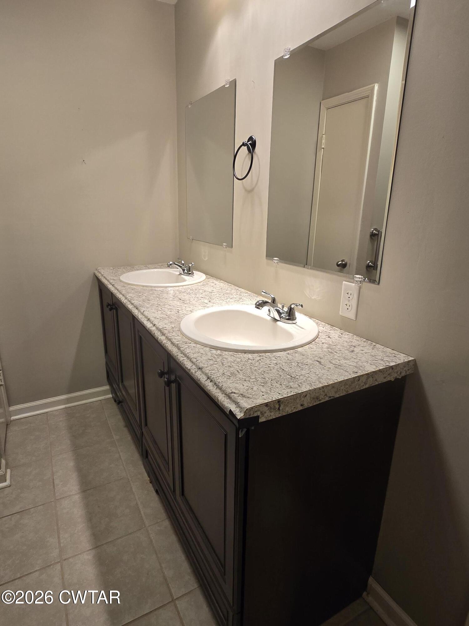 18 Lake Avenue Jackson, TN 38301 - Photo 12 of 19 a bathroom with a granite countertop sink and a mirror