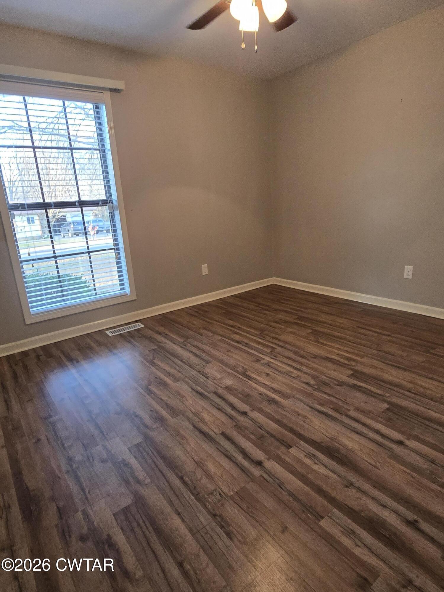 18 Lake Avenue Jackson, TN 38301 - Photo 15 of 19 wooden floor in an empty room with a window