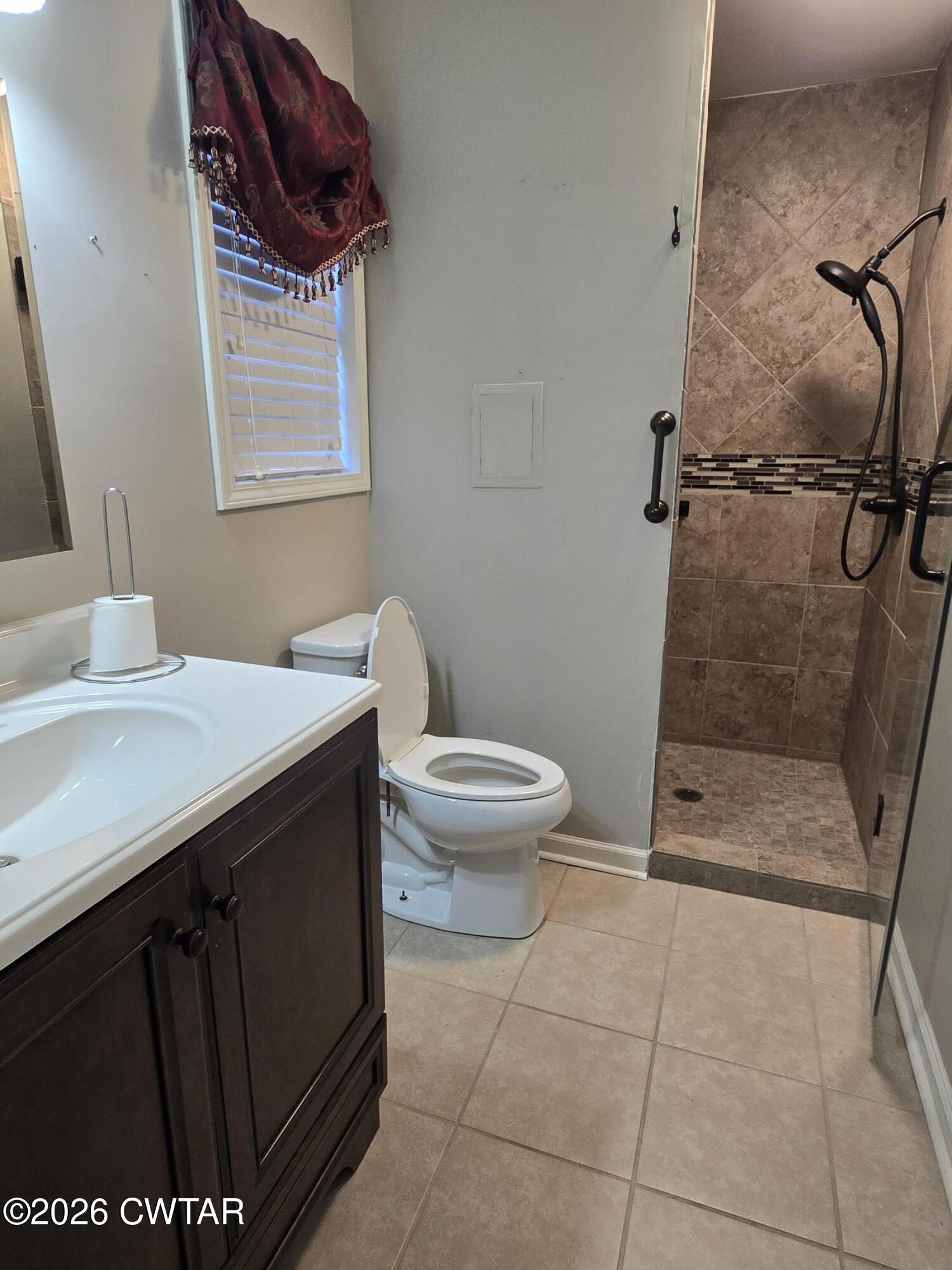 18 Lake Avenue Jackson, TN 38301 - Photo 16 of 19 a bathroom with a granite countertop sink a toilet and a mirror