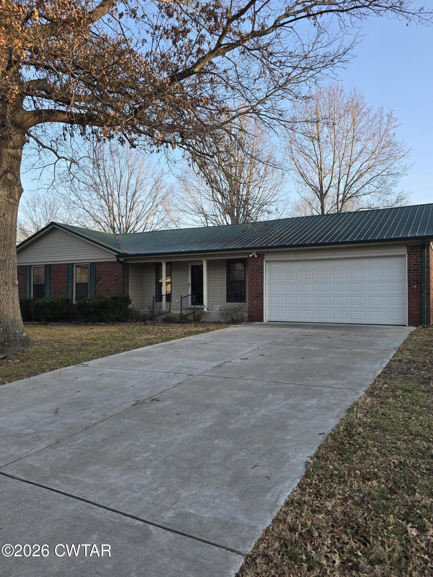 18 Lake Avenue Jackson, TN 38301 - Photo 18 of 19 a front view of a house with a yard and garage