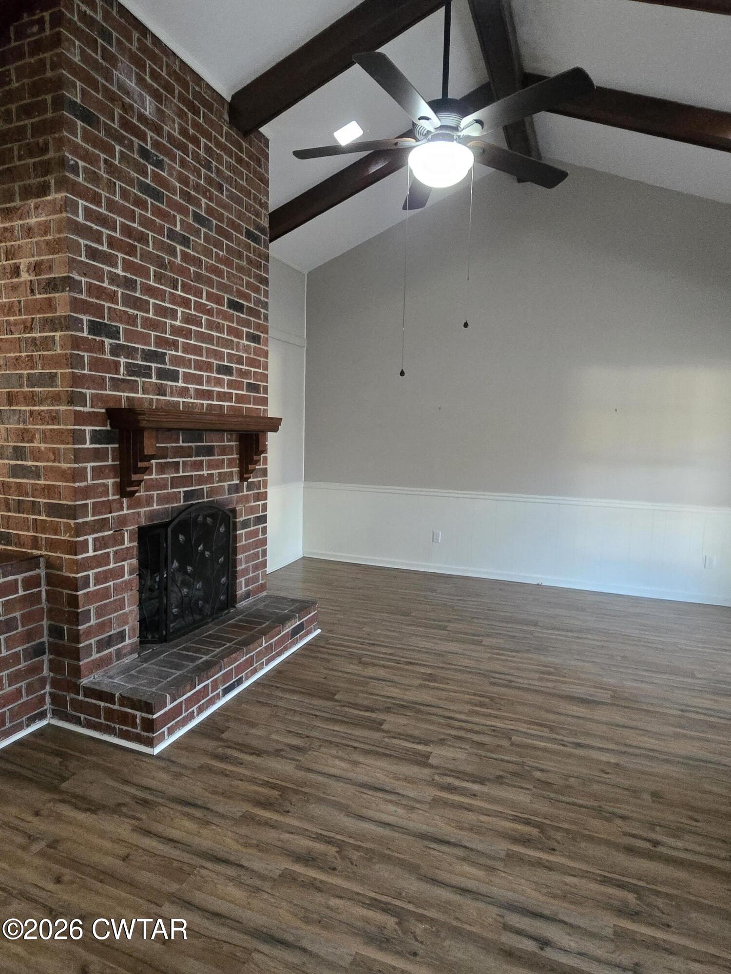 18 Lake Avenue Jackson, TN 38301 - Photo 7 of 19 a view of empty room with wooden floor and fireplace