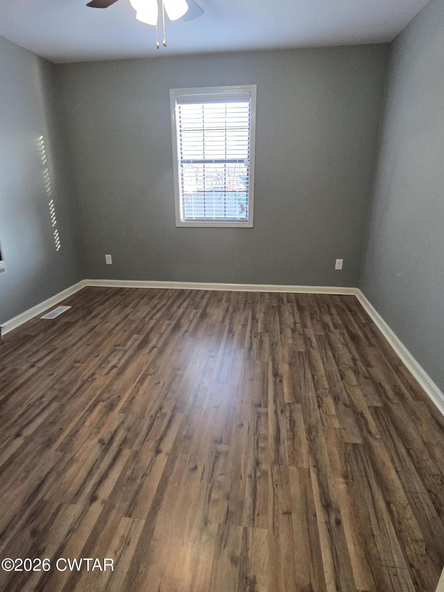 18 Lake Avenue Jackson, TN 38301 - Photo 10 of 19 wooden floor in an empty room with a window