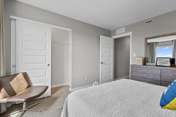 a bedroom with a bed and chair