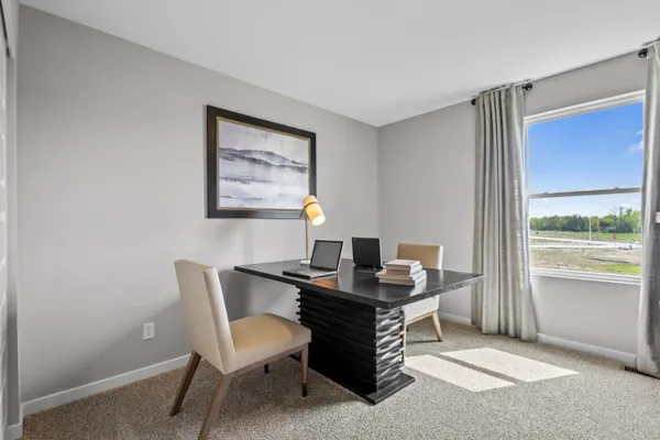 a workspace with furniture and window