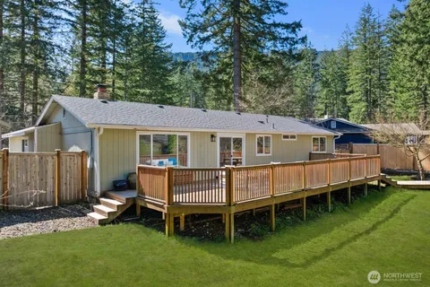 a view of a house with a yard and sitting area