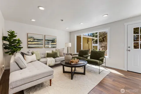 a living room with furniture and a potted plant