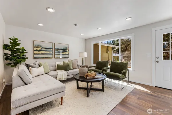 a living room with furniture and a potted plant