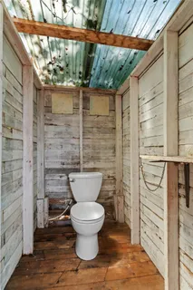 a bathroom with a toilet and a shower