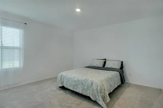 a bedroom with a bed and window