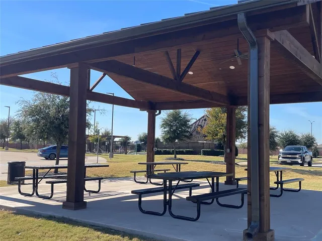 a view of swimming pool with a table and chairs in patio