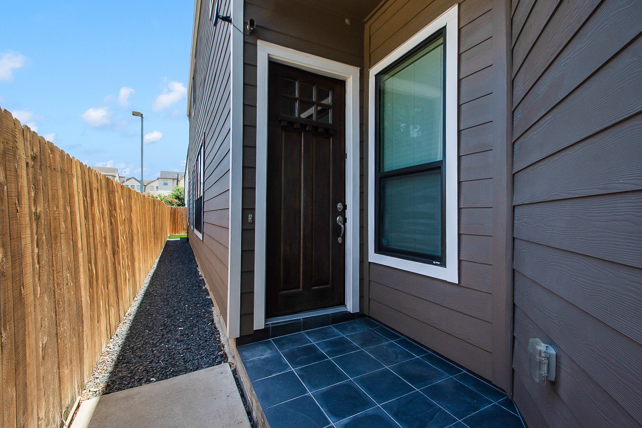 5328 Larkin Street Houston, TX 77007 - Photo 27 of 28 Extensive Black Star gravel landscaping adds both curb appeal and functionality, creating clean, low-maintenance outdoor spaces along the side yard and backyard while enhancing drainage and usability.