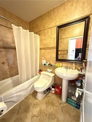 a bathroom with a sink toilet a mirror and tub