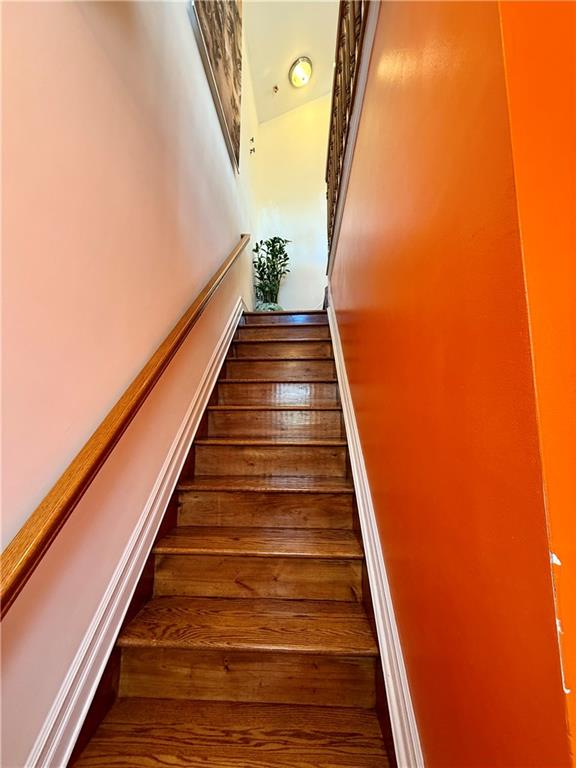 8752 18th Avenue, Unit 3E Brooklyn, NY 11214 - Photo 3 of 15 a view of balcony with wooden floor and stairs