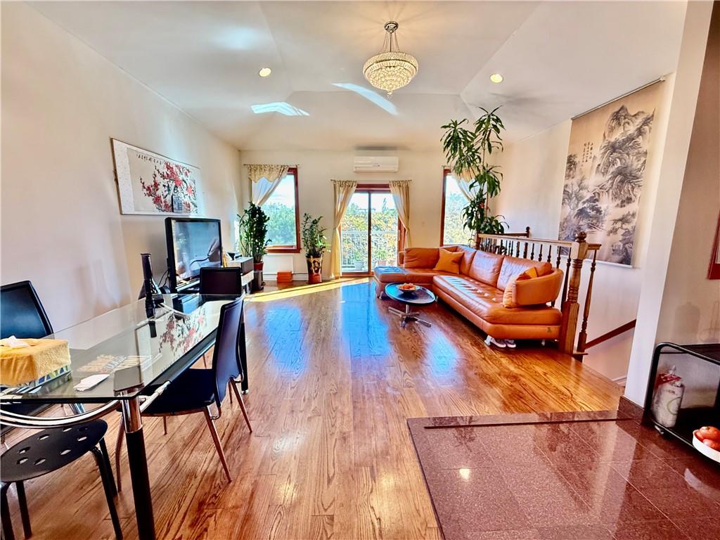 8752 18th Avenue, Unit 3E Brooklyn, NY 11214 - Photo 5 of 15 a living room with furniture and wooden floor