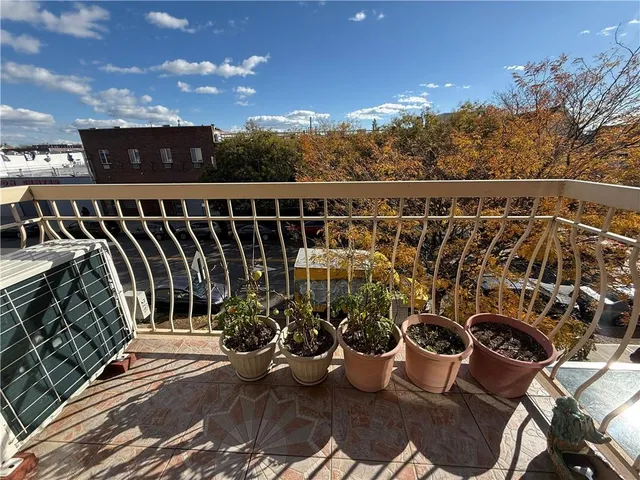 a view of a balcony with chairs and potted plants