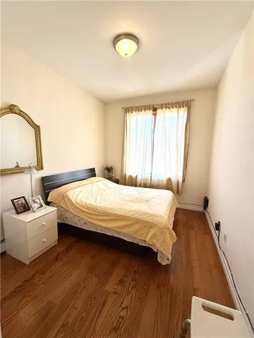a bedroom with a bed window and a couch
