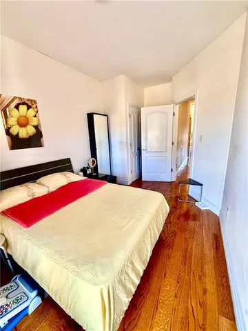 a bed sitting in a bedroom next to a window