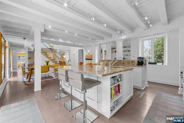 a large white kitchen with a large window