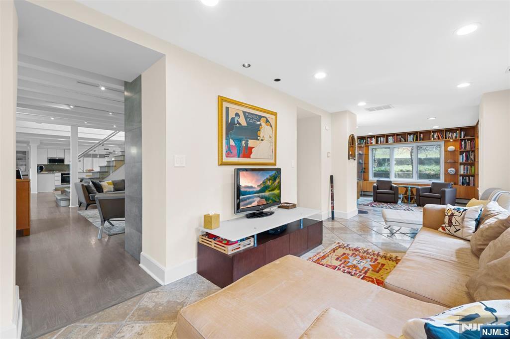 67 Forest Road Tenafly, NJ 07670 - Photo 15 of 42 a living room with furniture and a flat screen tv