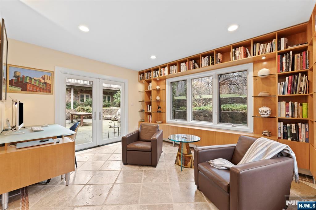67 Forest Road Tenafly, NJ 07670 - Photo 16 of 42 a living room with furniture cabinets and a flat screen tv