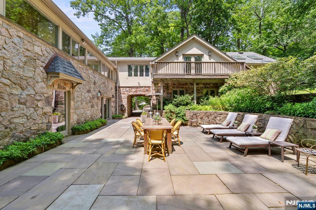 67 Forest Road Tenafly, NJ 07670 - Photo 27 of 42 a view of a patio with a table and chairs under an umbrella