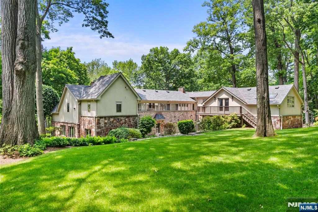 67 Forest Road Tenafly, NJ 07670 - Photo 33 of 42 a front view of a house with garden