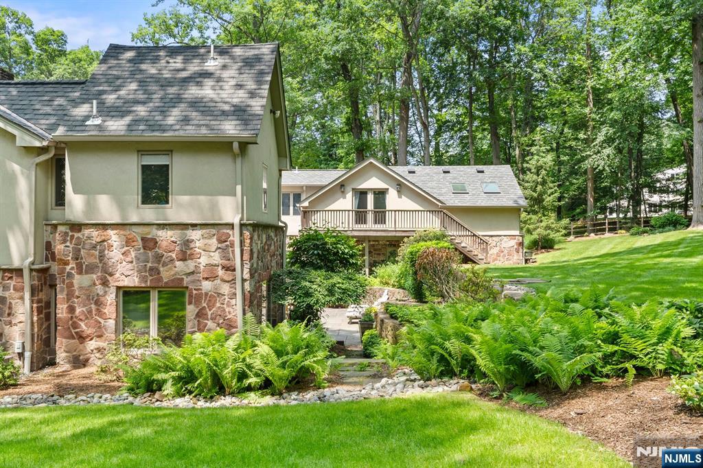 67 Forest Road Tenafly, NJ 07670 - Photo 36 of 42 a view of a house with brick walls and a yard with plants
