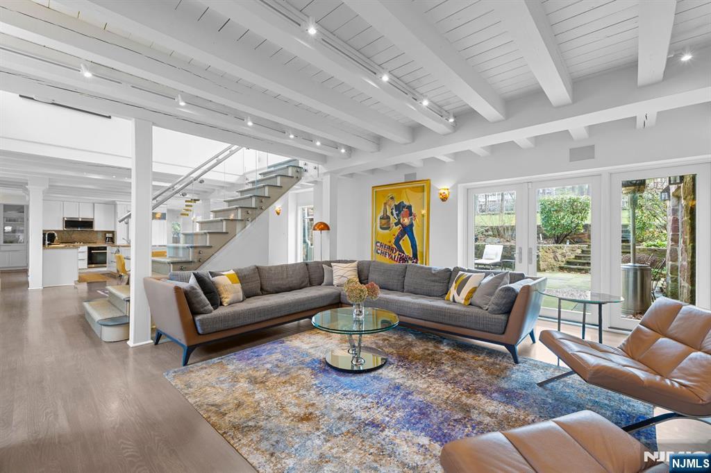 67 Forest Road Tenafly, NJ 07670 - Photo 8 of 42 a living room with furniture ceiling fan and a rug