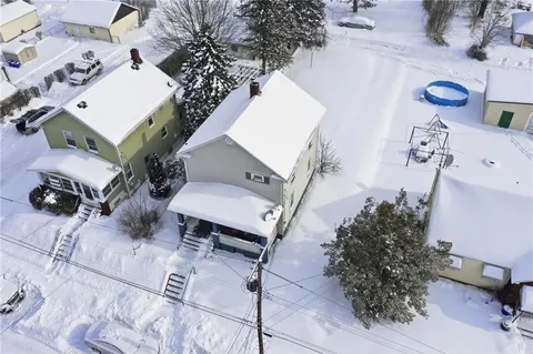 an aerial view of a house with a yard and balcony