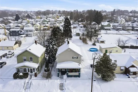 an aerial view of multiple houses with a yard