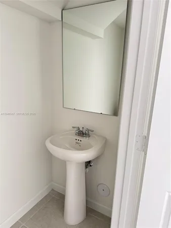 a bathroom with a sink a mirror and a toilet