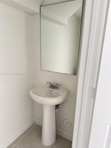 a bathroom with a sink a mirror and a toilet