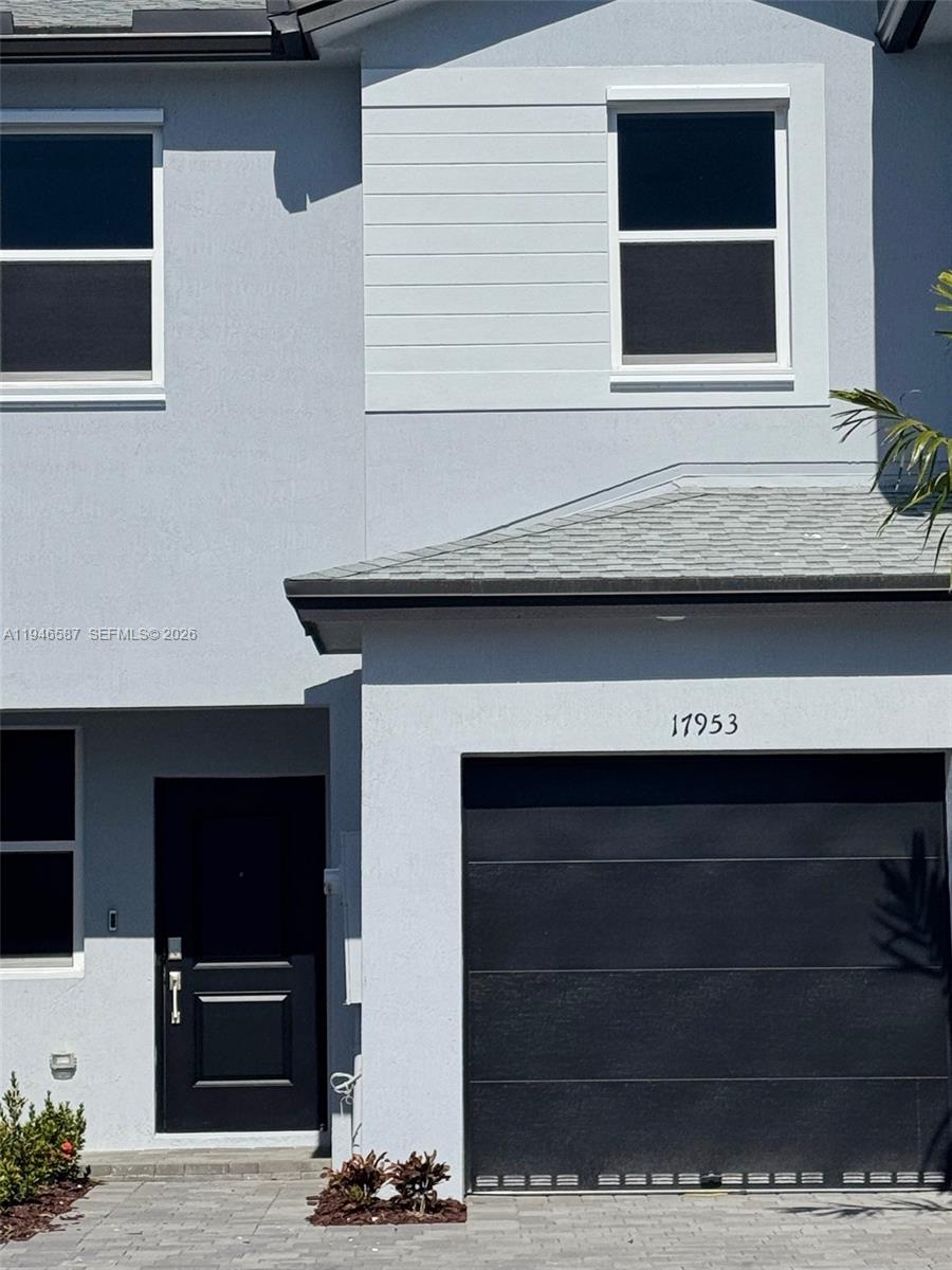 17953 Southwest 359th Street, Unit 17953 Homestead, FL 33034 - Photo 2 of 32 a living room with a fireplace and a flat screen tv