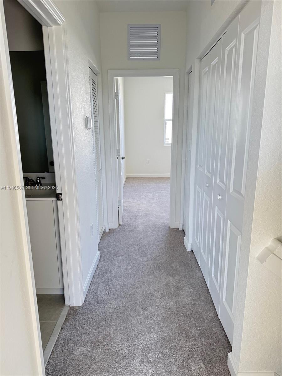 17953 Southwest 359th Street, Unit 17953 Homestead, FL 33034 - Photo 23 of 32 a view of a hallway with wooden floor and entryway