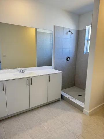 a bathroom with a toilet sink and shower