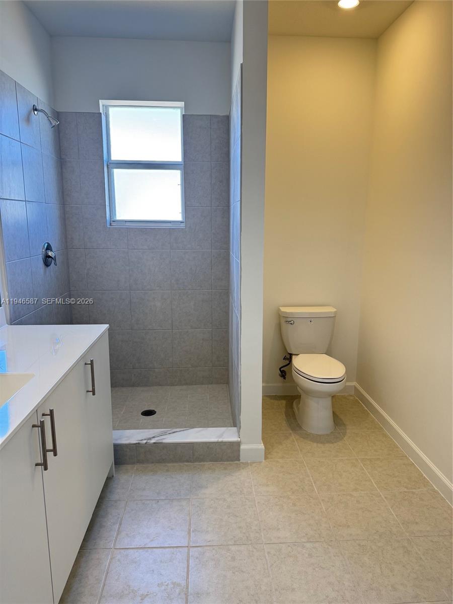 17953 Southwest 359th Street, Unit 17953 Homestead, FL 33034 - Photo 26 of 32 a bathroom with a toilet sink and shower