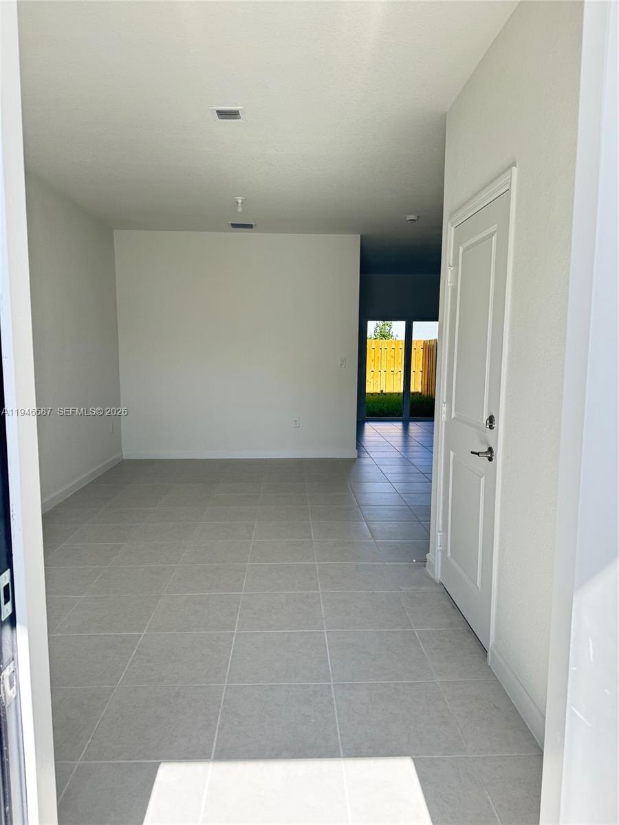 17953 Southwest 359th Street, Unit 17953 Homestead, FL 33034 - Photo 8 of 32 a view of an empty room with a window