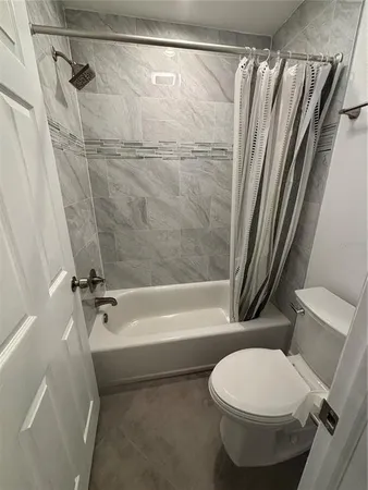 a bathroom with a shower and a bath tub