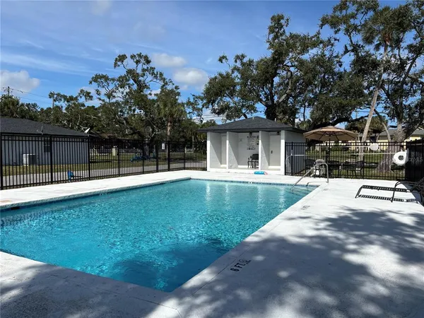 a view of swimming pool with yard and green space