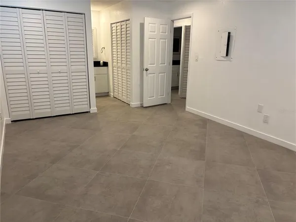 a view of a room with white cabinets