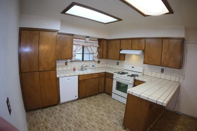 a kitchen with a sink appliances and cabinets