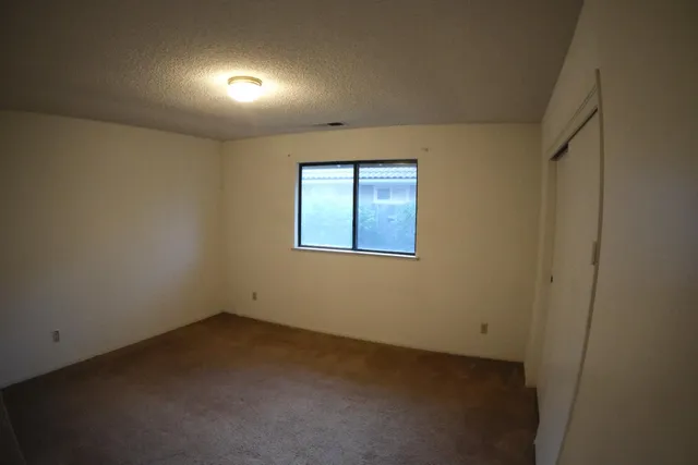 an empty room with a empty space and windows