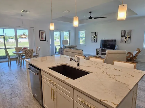 a view of kitchen island a sink and living room view