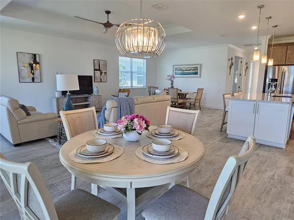 a view of a dining room with furniture and a chandelier
