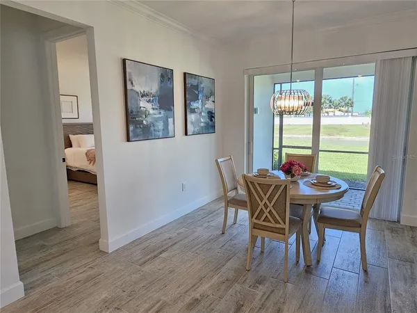 a view of a dining room with furniture window and wooden floor