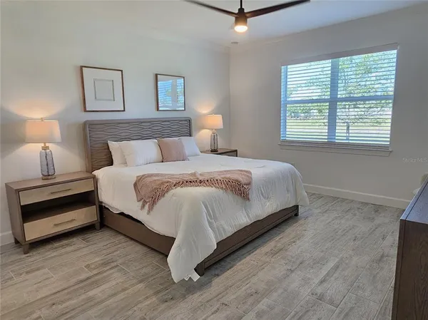 a bedroom with a bed and a night stand