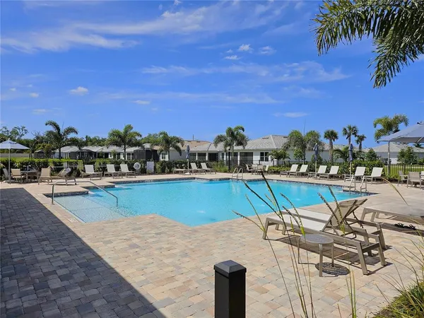 a view of a swimming pool with a table and chairs