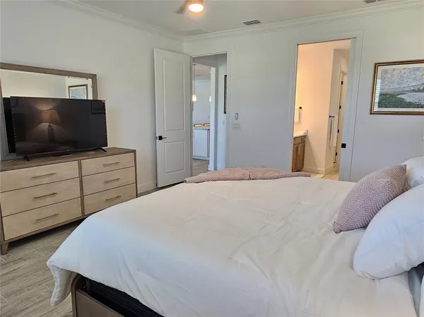 a bedroom with a bed and a flat screen tv