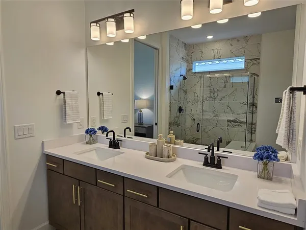 a bathroom with double sink and a mirror