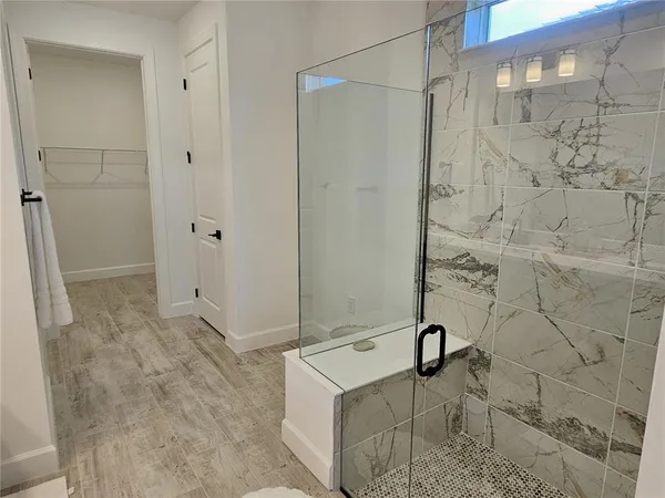 a bathroom with a granite countertop shower